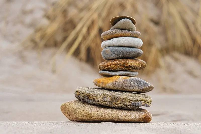 A stack of carefully balanced stones, representing the effort of trying to stay organised when traditional planners do not work with ADHD.
