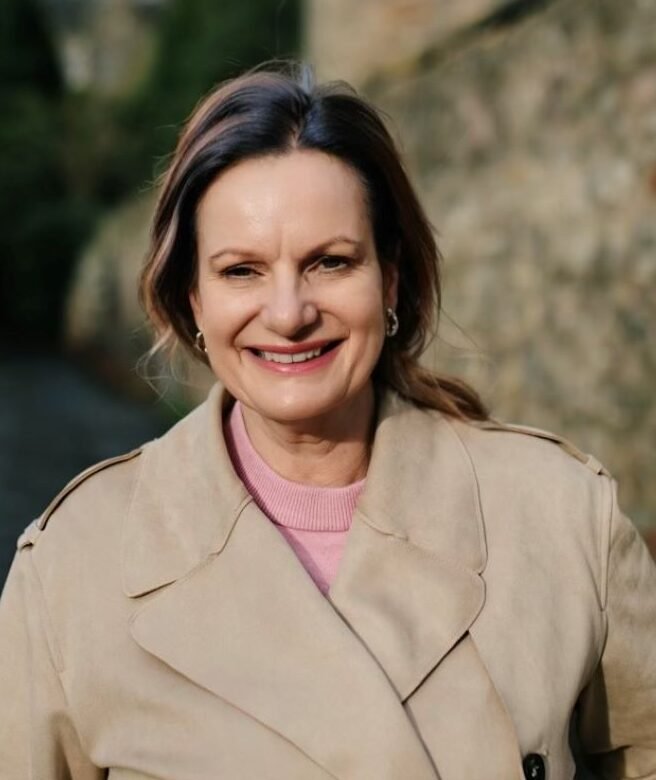 ADHD coach Carol outdoors smiling in natural setting