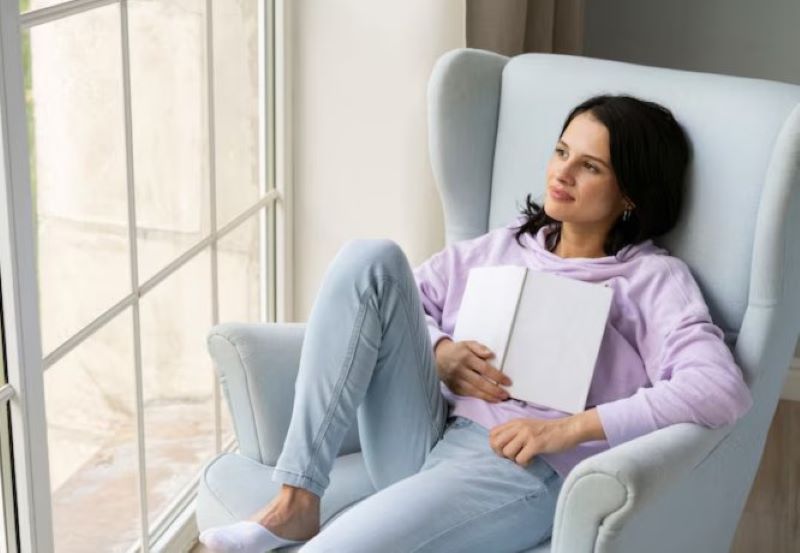 woman relaxing on a chair reflecting