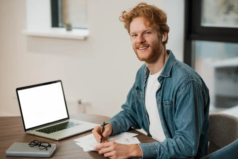 Man working on a laptop using The Clear Forward Tools ADHD strategy framework to stay focused and organised.