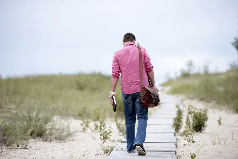 Person walking along a boardwalk, reflecting on progress and the everyday challenges of ADHD.