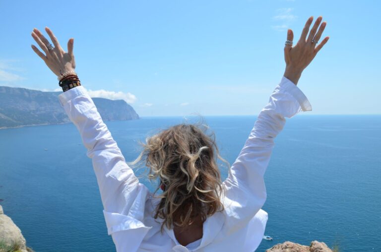 Woman with arms raised in celebration, symbolising self-praise and personal achievement in ADHD growth.
