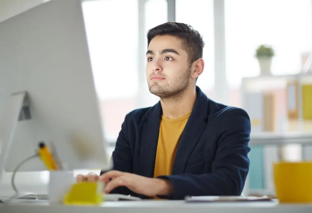 Man studying and planning at his desk, representing focus and productivity through ADHD coaching
