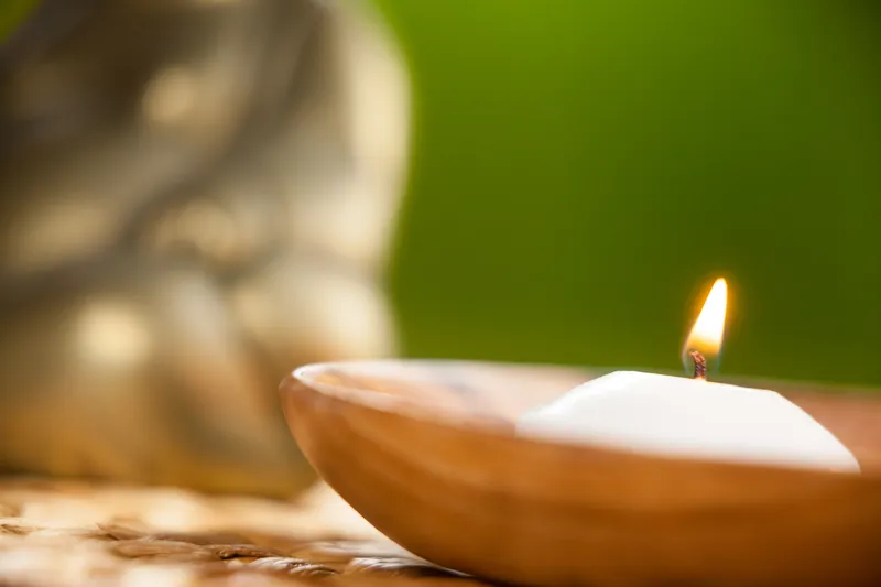 A close-up of a lit candle, representing finding moments of calm during ADHD emotional overwhelm.