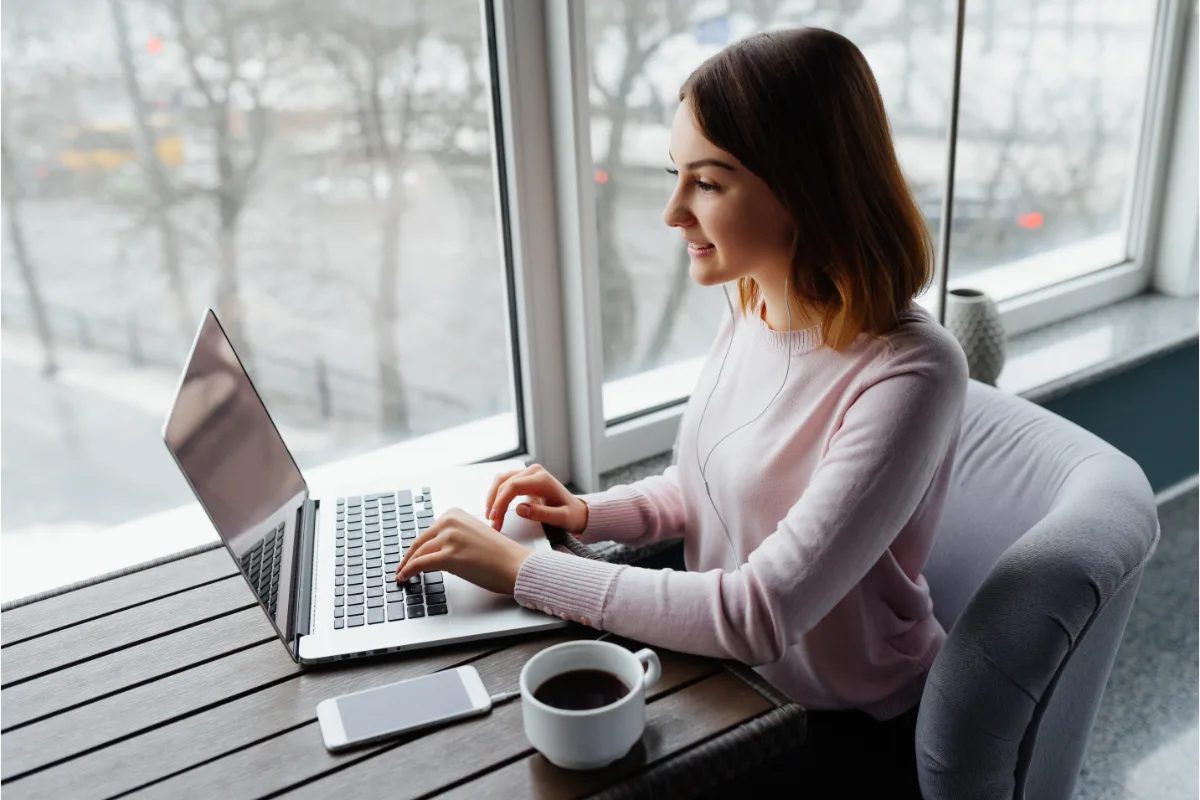 Woman working in a cafe on her laptop