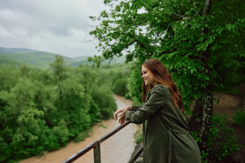 Woman overlooking green landscape reflecting on freedom self-understanding and finding calmer ways to live with ADHD