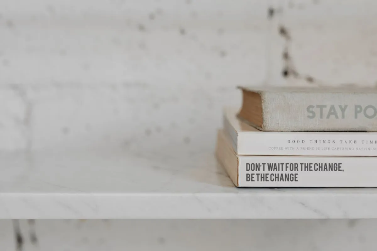 Stack of self-development books representing inner reflection and personal growth
