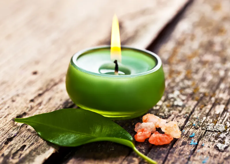 A close-up of a lit candle, representing the calm, self-awareness and emotional wellbeing that ADHD coaching can help develop alongside practical strategies.