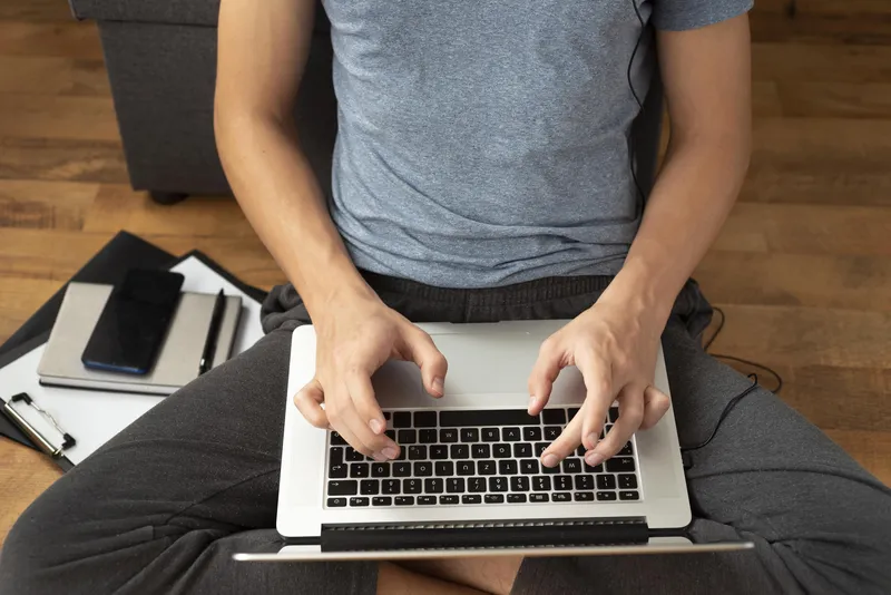 A close-up of someone working on a laptop, representing the burst of focus and motivation that often appears when deadlines become urgent with ADHD.