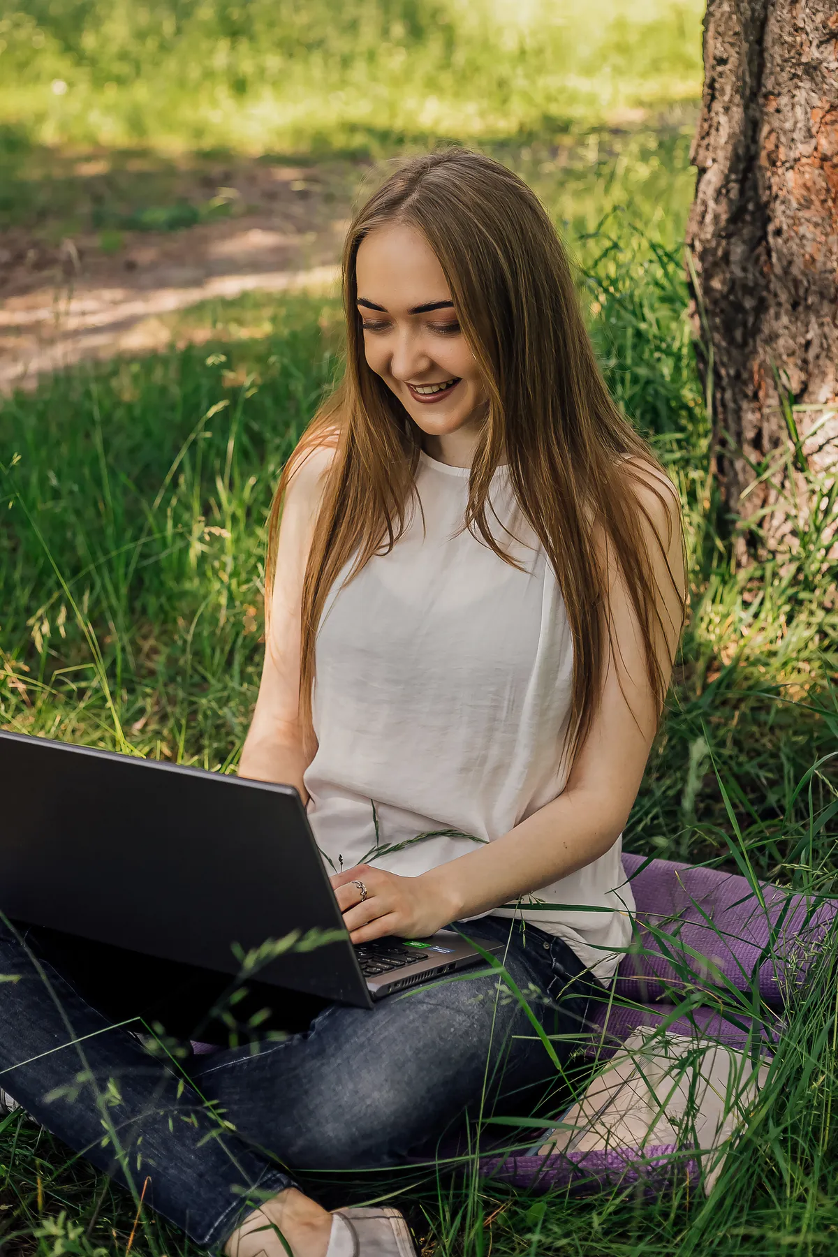 Person using a laptop outdoors, representing a welcoming first step towards ADHD coaching and online support.
