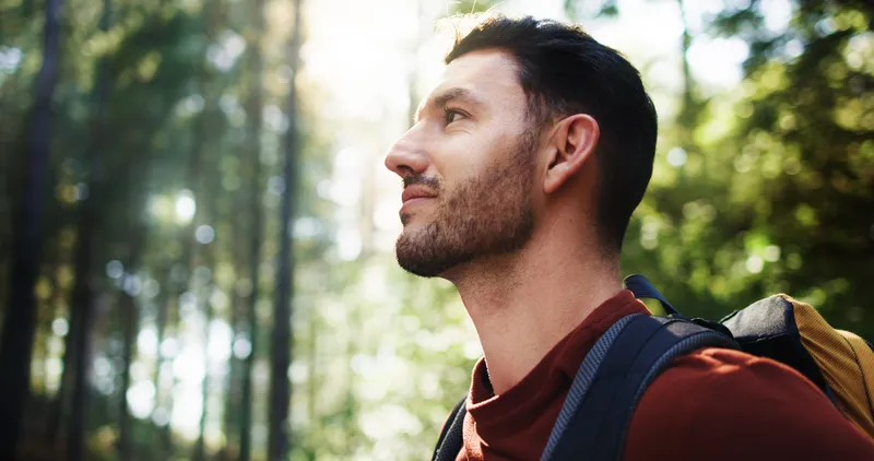 Person reflecting in nature, representing finding your way forward through ADHD coaching.