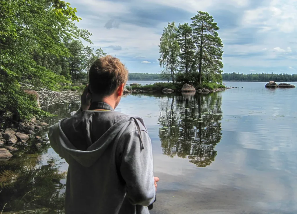 Man looking across a lake reflecting on when planners don't work with ADHD.