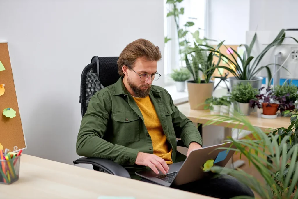 Man sitting in his home office representing the challenge of staying focused with ADHD.