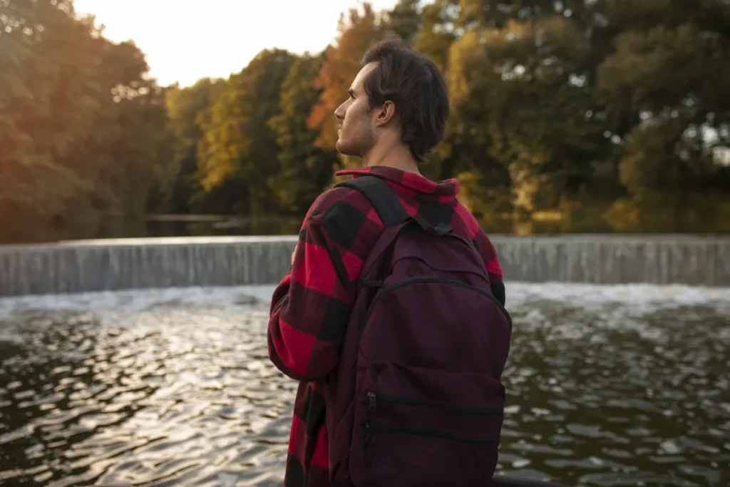 Man standing by a river reflecting on seeing your own progress with ADHD.