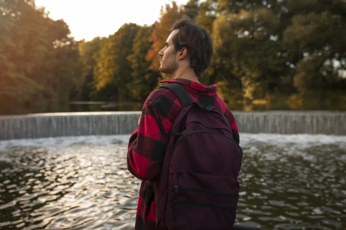 Man standing by a river reflecting on seeing your own progress with ADHD.