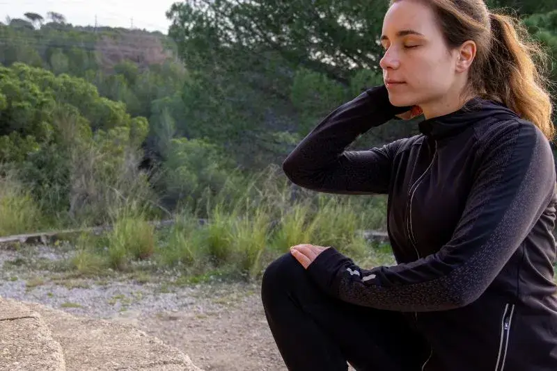 woman with ADHD sitting outside trying to manage mental overload
