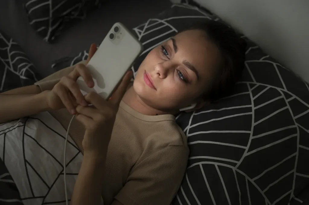 Woman lying in bed representing ADHD task paralysis and feeling overwhelmed.