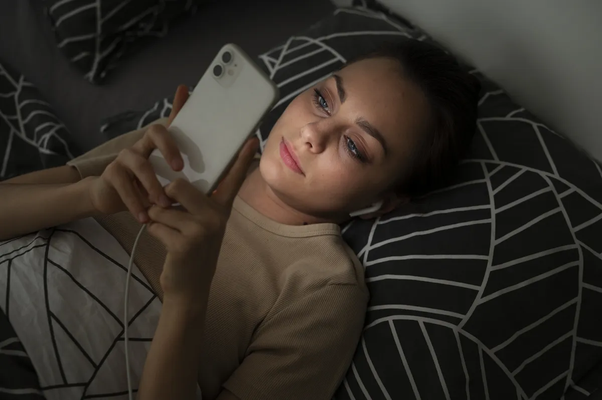Woman lying in bed representing ADHD task paralysis and feeling overwhelmed.