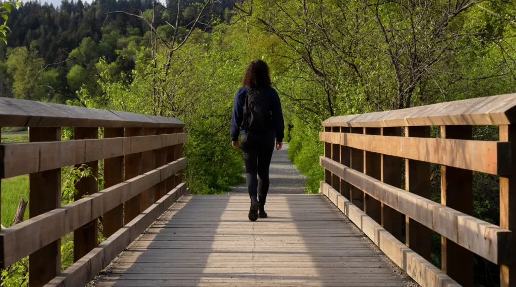 Woman walking across a bridge representing learning to trust yourself with ADHD.